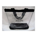 A clear plastic beach tote bag with black handles and a black base, photographed against a white fabric background. The text 'handy caddy' is printed on the front.